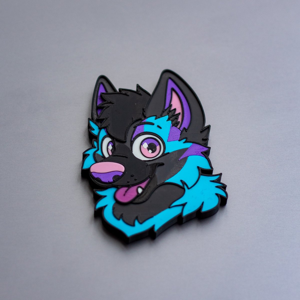 Custom fursona magnet example: Taff the Yeen, a black hyena head with cyan fur and purple stripes
